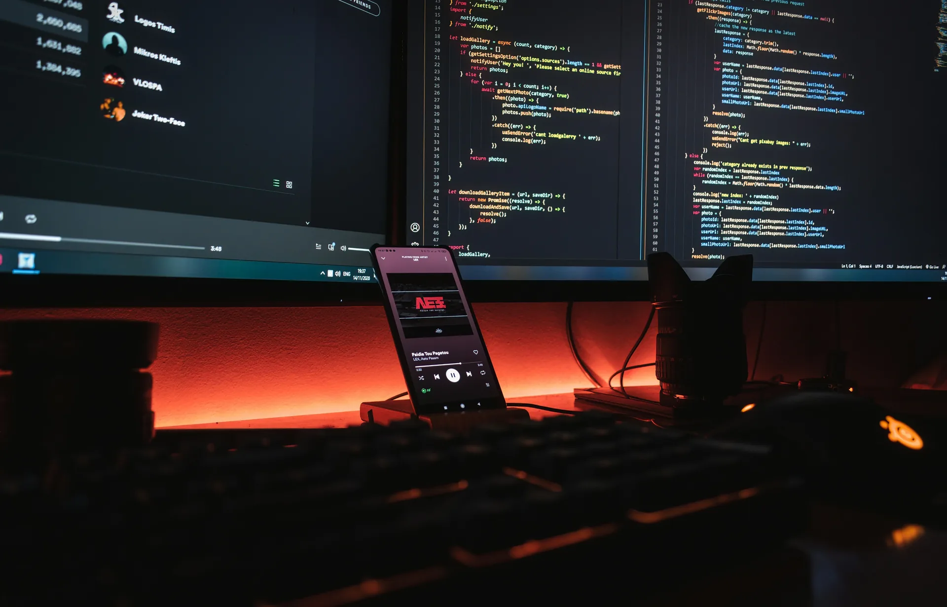 Developer desk with code on a dark monitor