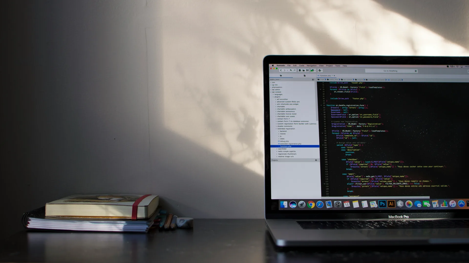 Laptop with development tools in soft shadow light