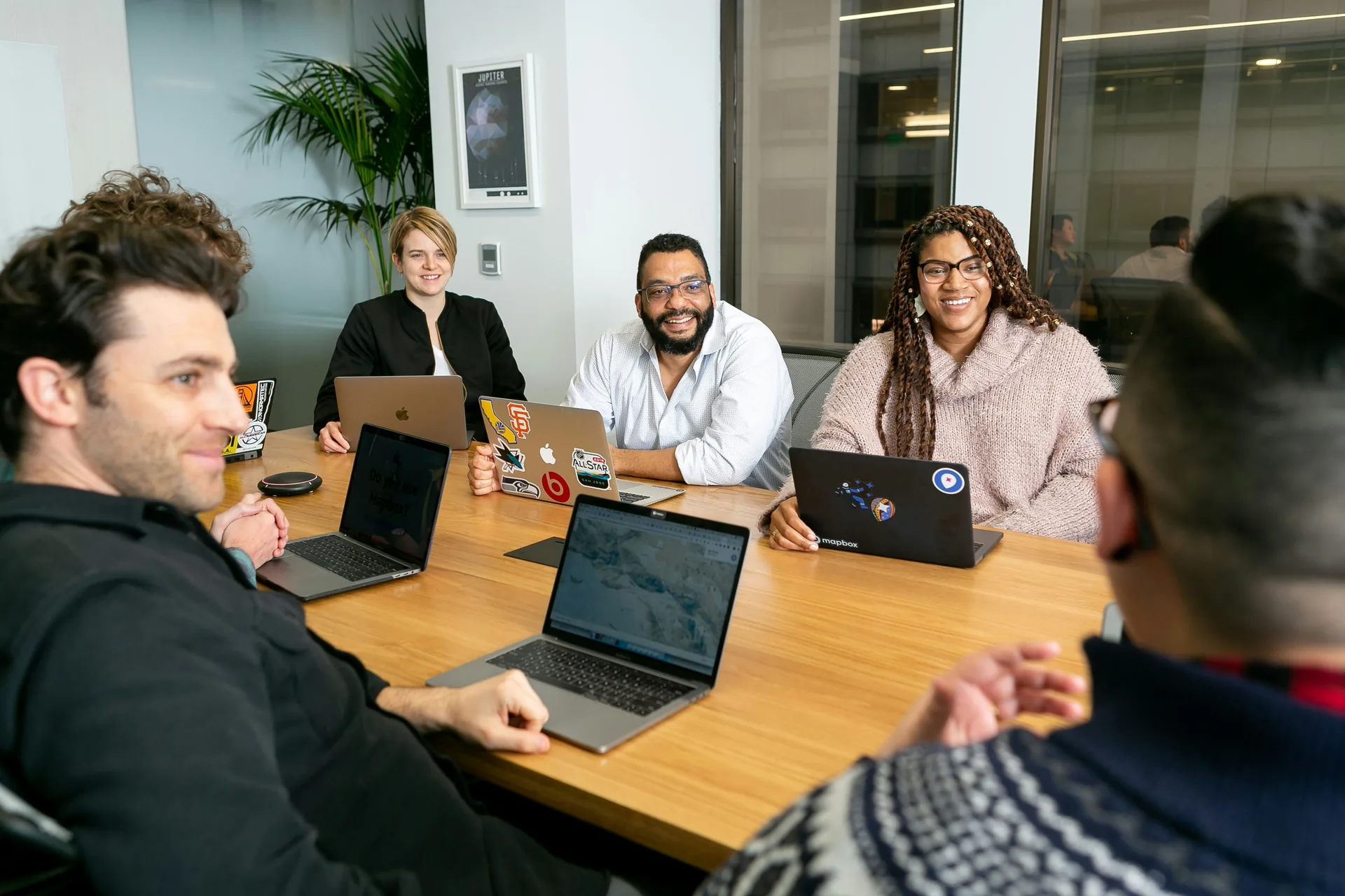 Team meeting with laptops and discussion