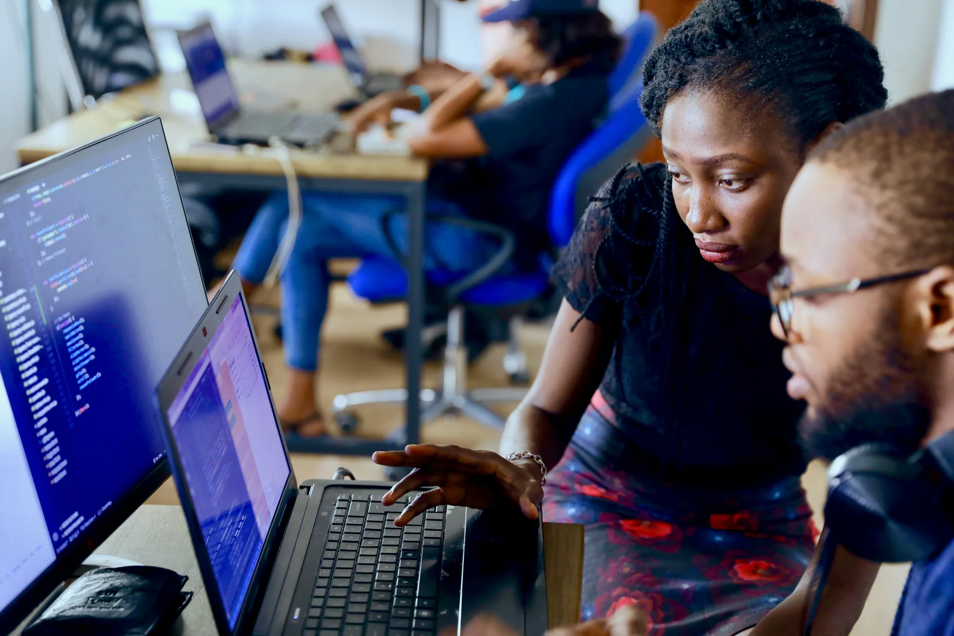 Two developers pair programming at one screen